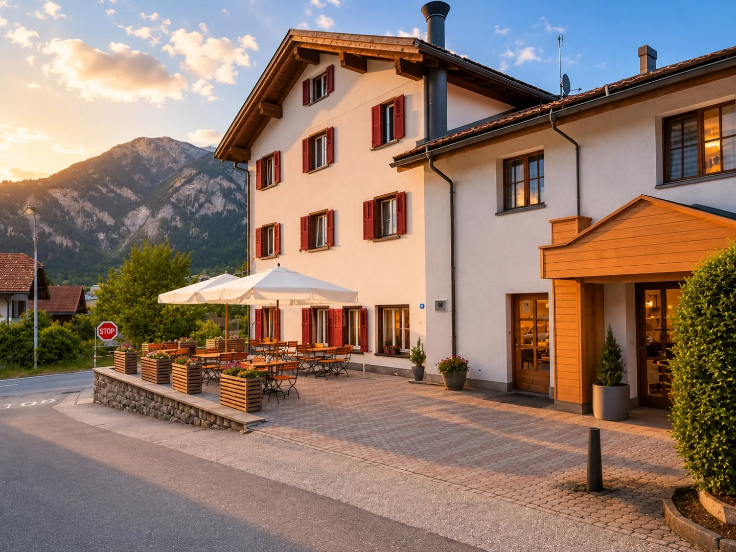 Alpine Hotel Reich at dusk — warmly lit against the evening sky, nestled in the Swiss Alps
